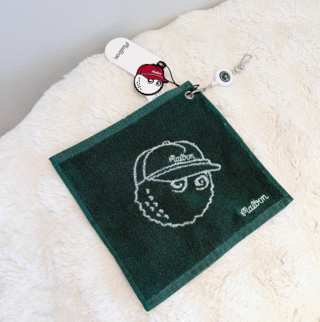 Malbon Golf Towel & Keychain Gift Set 2026 — wiping a golf clubface
