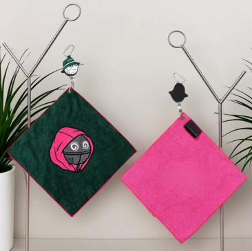 Malbon Microfiber Golf Towel with Clip — wiping a golf clubface