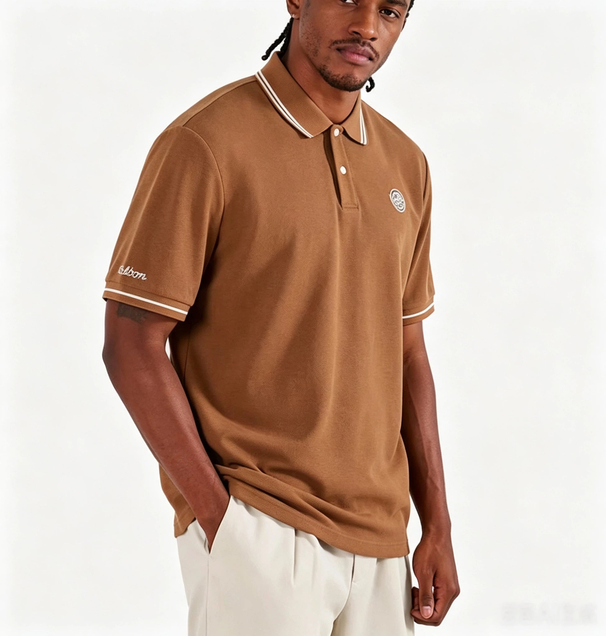 Model wearing Malbon black moisture-wicking golf polo