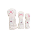 White corduroy golf headcovers set with pink flower accents and立体GOLF letters, designed for driver, fairway and utility clubs with durable protection.
