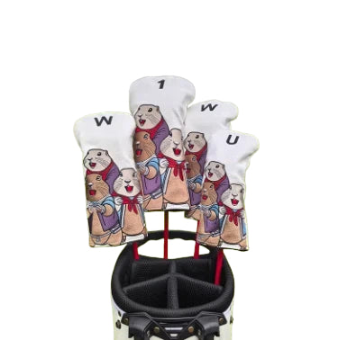 Front view of a white marmot-themed golf headcover set featuring colorful cartoon marmots wearing red scarves and purple vests, labeled with "W", "U", and "1" for easy club identification, displayed inside a black golf bag.