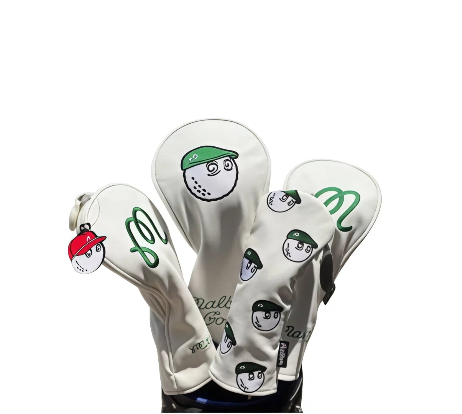 Set of white Malbon Golf headcovers featuring cartoon golf balls wearing green and red baseball caps, with embroidered "Malbon Golf" script and playful designs — perfect for protecting driver, fairway wood, and hybrid clubs in fun, eye-catching style.