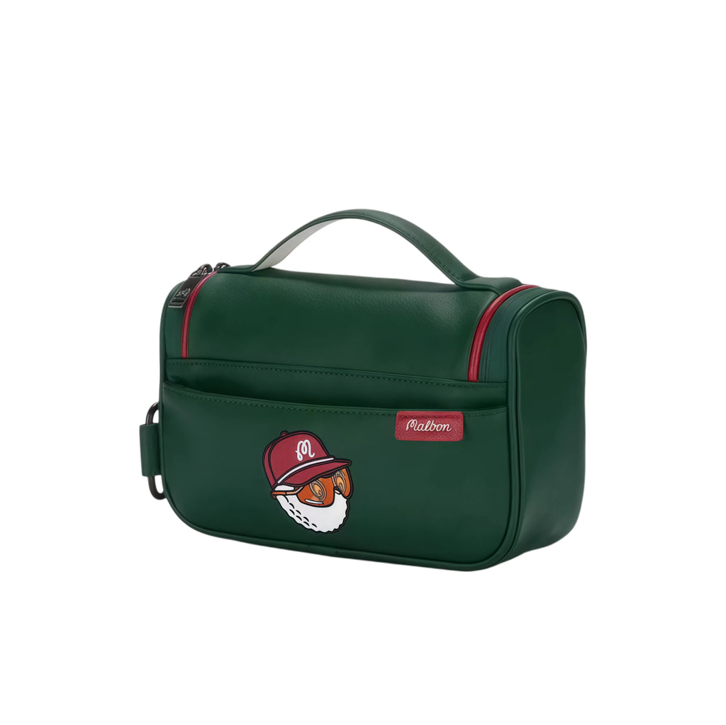 Dark green Malbon golf handbag with fun cartoon golf ball face wearing red cap and orange goggles, red zipper accents, and durable leather-like material for travel or golf use.