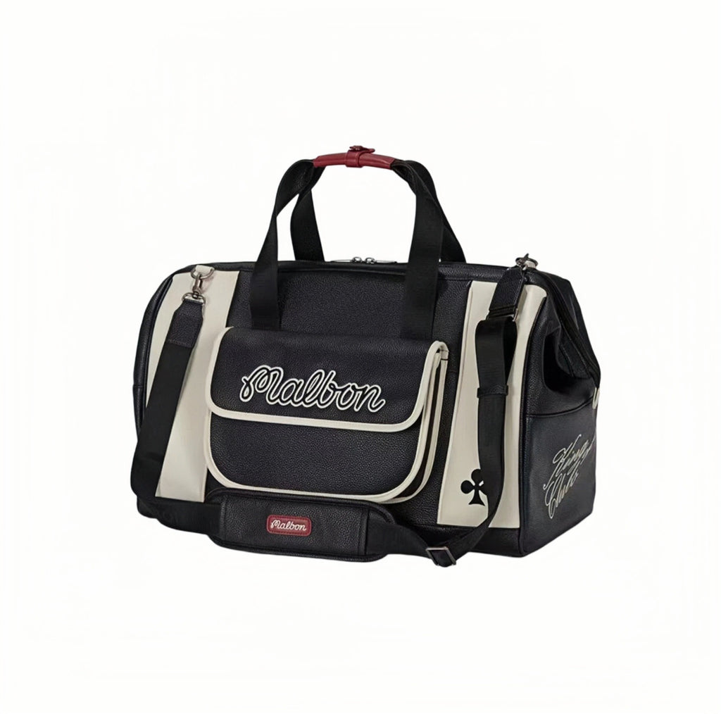 Side view of Malbon Golf Poker King duffle bag in black and cream PU leather, featuring embroidered "Malbon" logo on front flap, red top handle, and adjustable shoulder strap