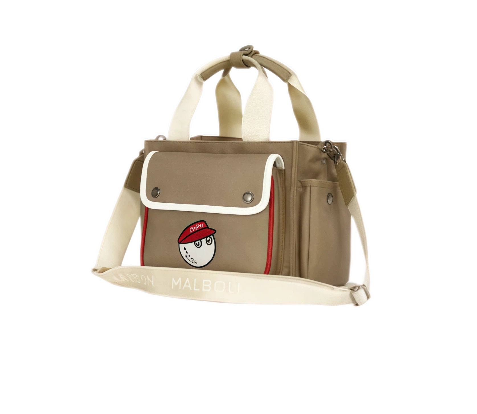 Angled view of beige Malbon golf tote bag with red-capped cartoon golf ball patch, adjustable cream shoulder strap labeled "MALBON", and structured sides.