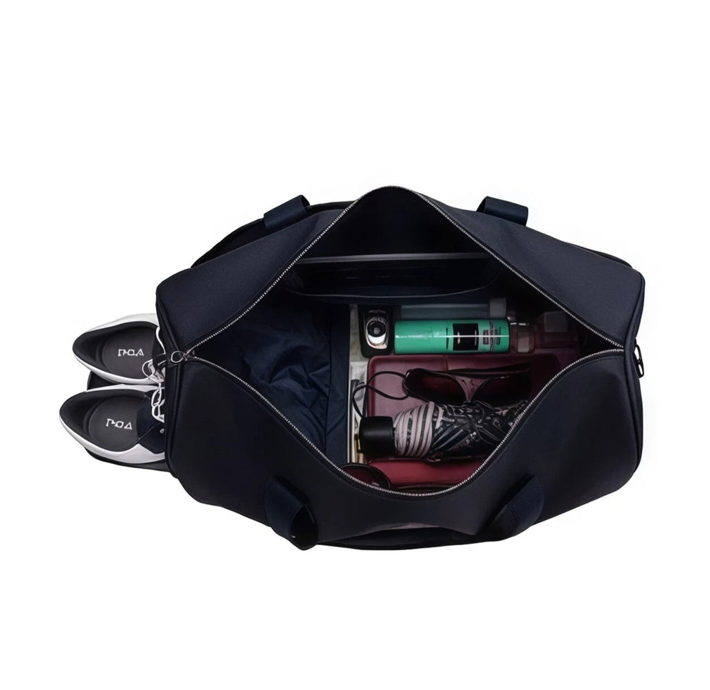 Open view of the PGA Tour duffel bag showing spacious interior with organized compartments, including a separate shoe pocket, clothing, toiletries, sunglasses, and a laptop sleeve. Designed for practicality and comfort.