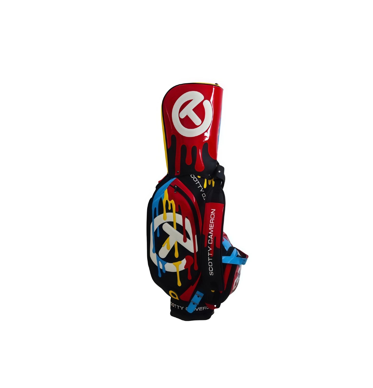 Front view of the Scotty Cameron 2025 Paint Drip Tour Bag. This premium staff bag features a striking black base with a vibrant, multi-color paint drip design in red, blue, and yellow, accented by a large white Circle T logo.