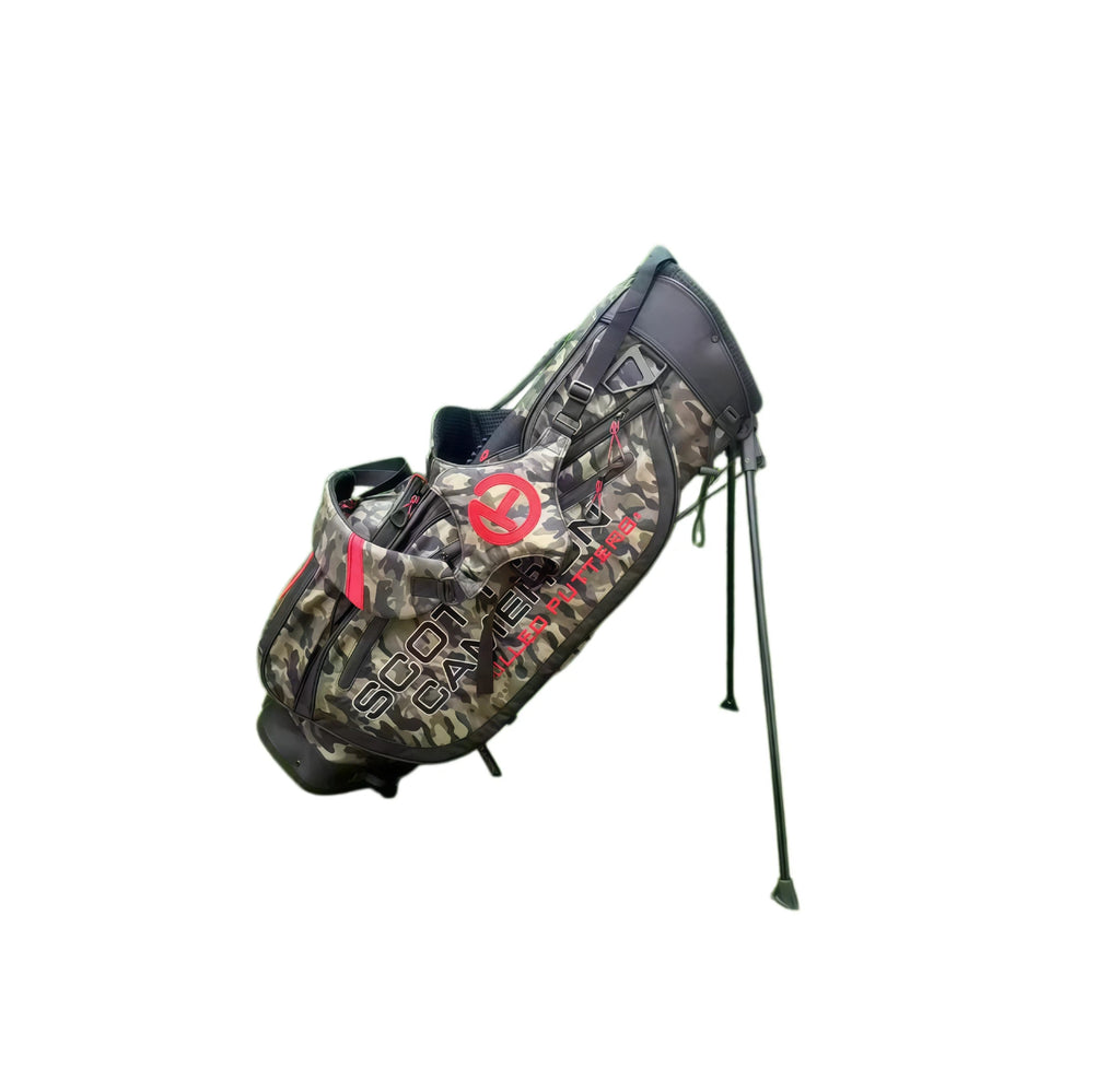 Angled view of the Scotty Cameron Pathfinder Camo/Red Stand Bag with its stand legs extended, displaying the durable camouflage fabric, red accent zippers, and the iconic Circle T branding on the side pocket.