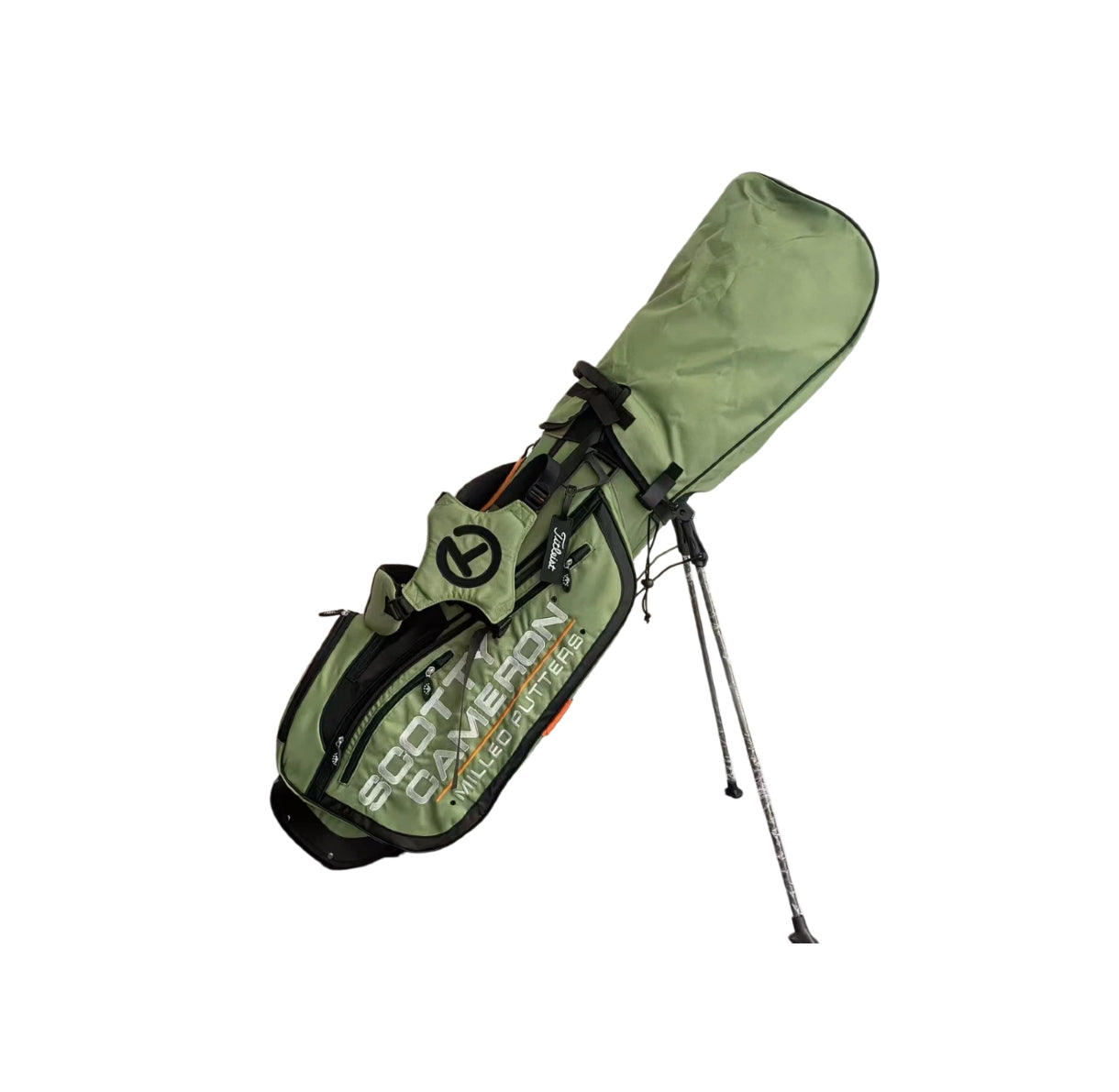 Angled view of the Scotty Cameron Pathfinder Stand Bag in Green, showcasing the dual strap system, extended stand legs, and durable fabric construction with orange detailing.