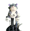 Front view of a plush gray and white cat golf headcover with purple ears, pink nose, and expressive eyes, sitting atop a driver shaft inside a black golf bag among other clubs.