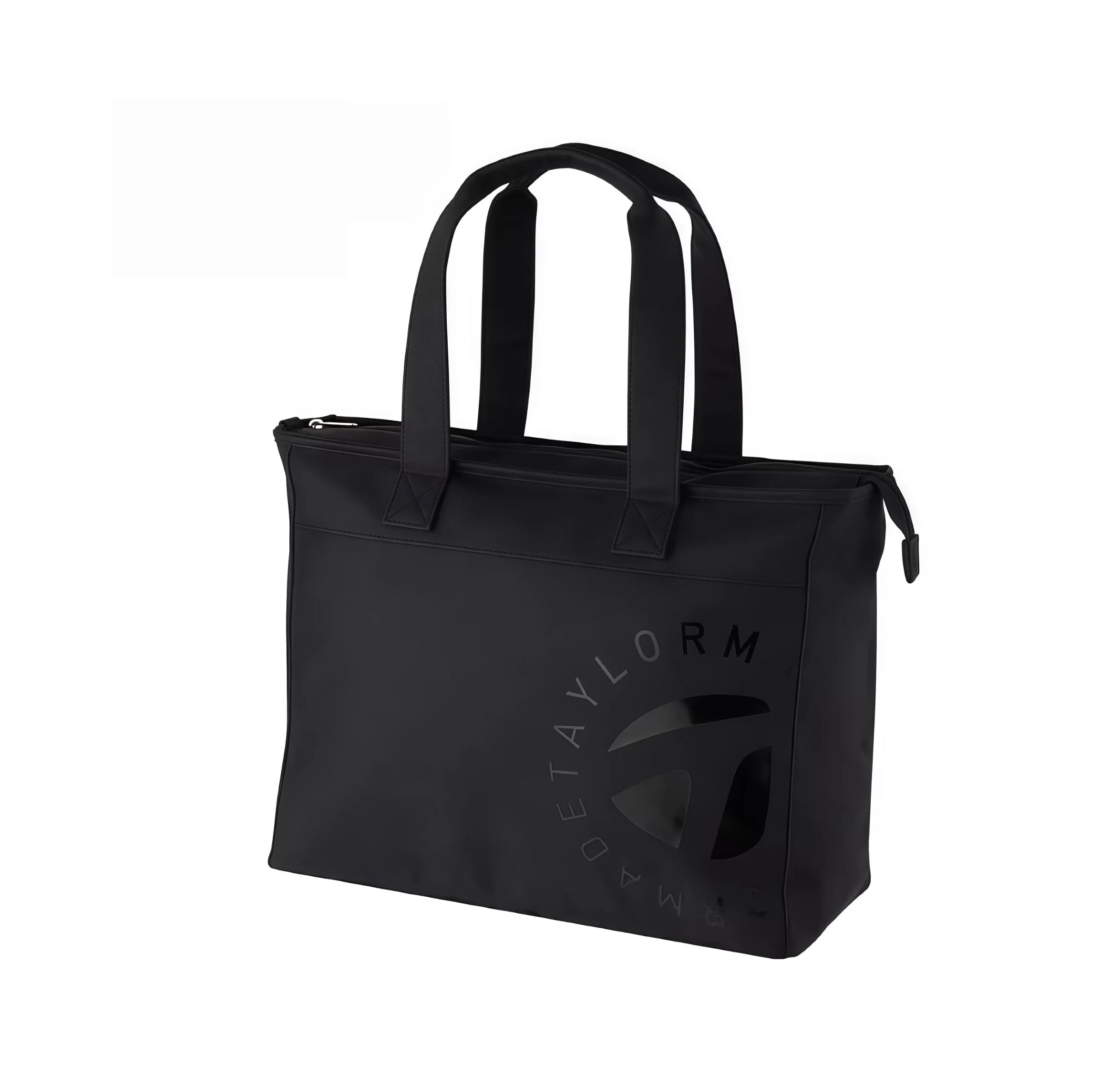 Front view of the TaylorMade Black Golf Tote featuring a subtle tonal "T" logo and circular "TAYLORMADE" text. Includes dual top handles and zippered closure for secure storage.
