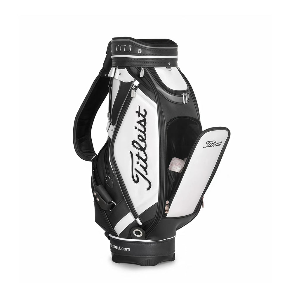Side view of the Titleist Classic Leather-Look Cart Bag in black and white with open top compartment showing club dividers. Features the "Titleist" logo, padded shoulder strap, and insulated cooler pocket. Ideal for organized storage.