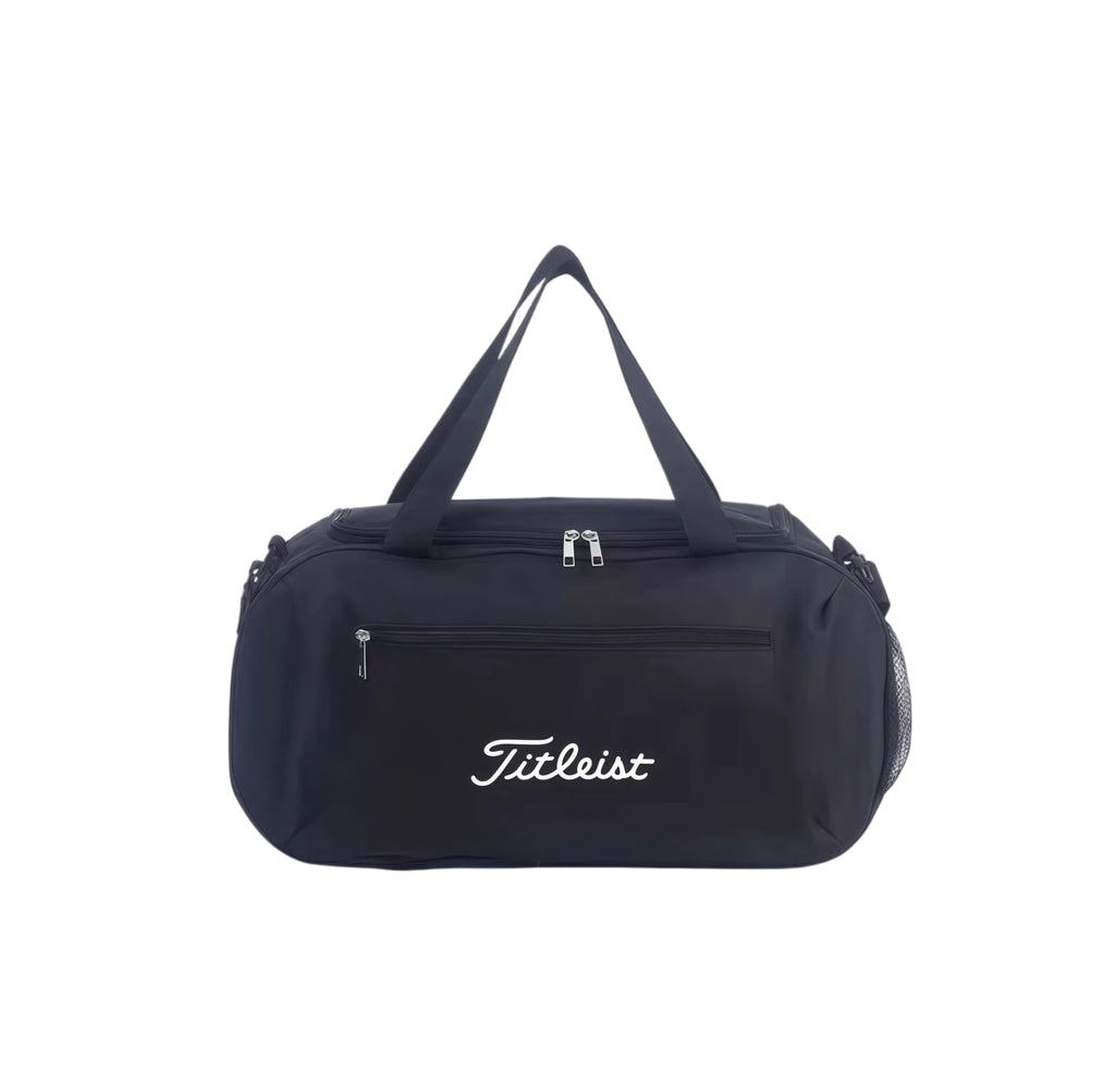 All-black Titleist Core Golf Boston Bag with white embroidered logo. Durable nylon construction with dual-zip main compartment and front zip pocket. Ideal for men and women.