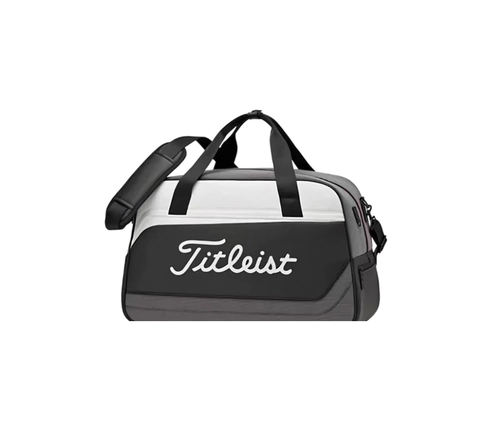 Titleist Duffel Bag in black and grey with white "Titleist" logo, structured design, and durable construction. Features dual handles and a padded crossbody strap for comfortable carrying.