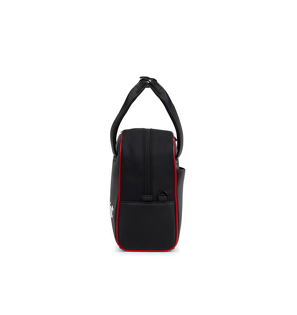 Black handbag with red accents on a white background