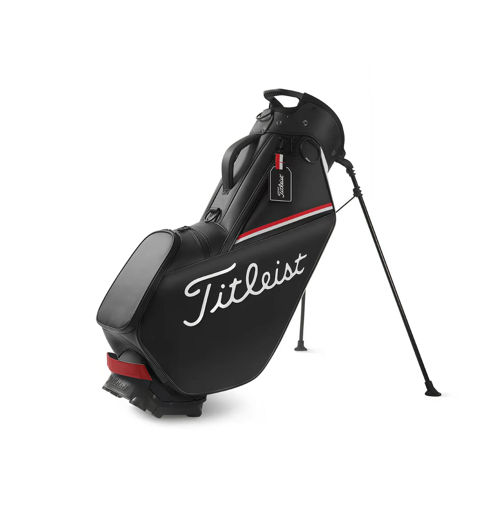 Side view of the all-black Titleist Players 4 Plus Stand Bag with white "Titleist" logo and red stripe. Features dual straps, reinforced base, and durable construction. Minimalist and professional look.
