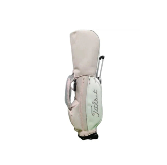 Front view of the Titleist Waterproof Stand Golf Bag featuring a retractable handle, dual wheels, and a sleek light pink and mint color scheme with the iconic Titleist script logo.