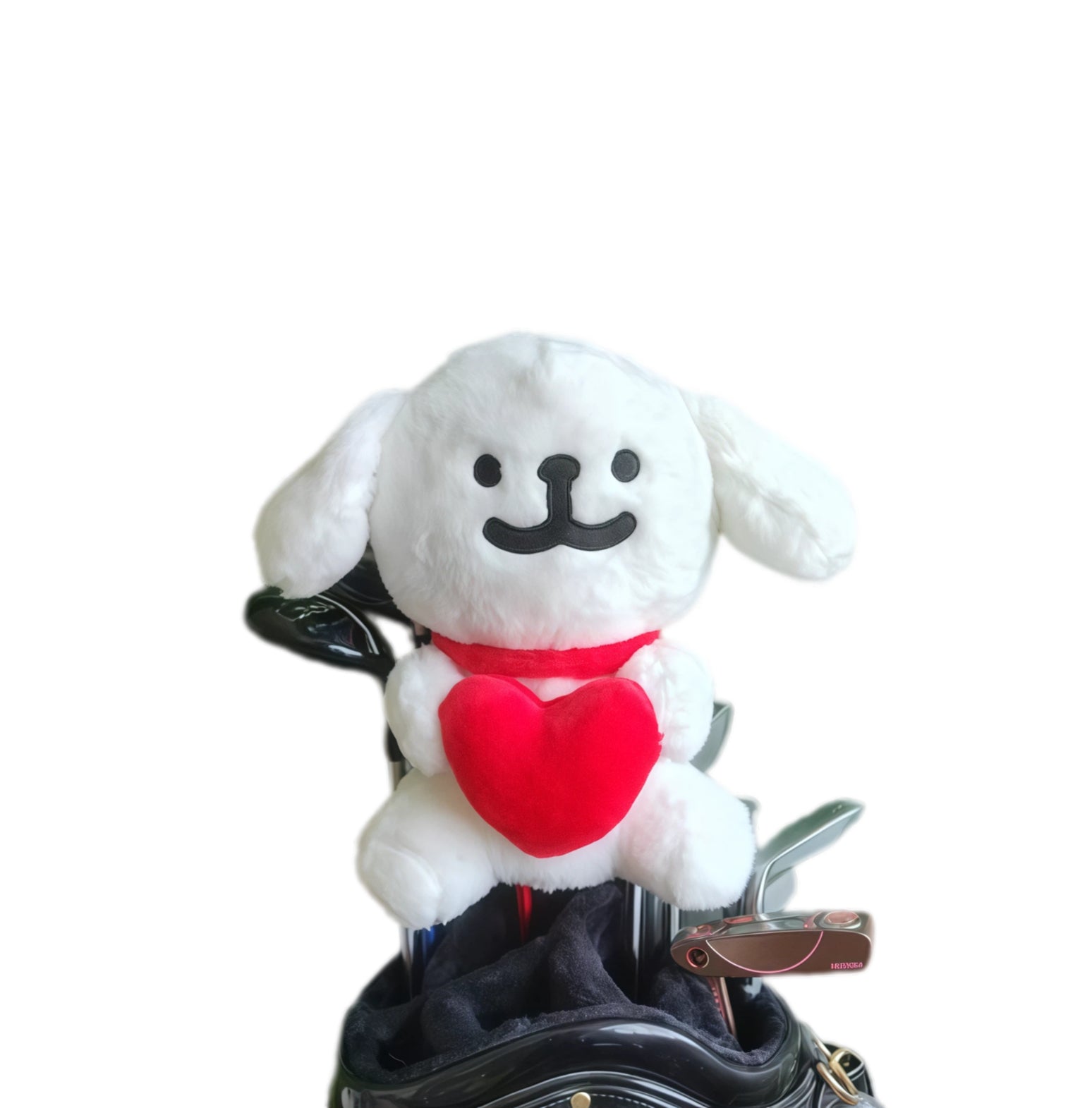 White plush dog with a red heart on a golf club head cover against a white background