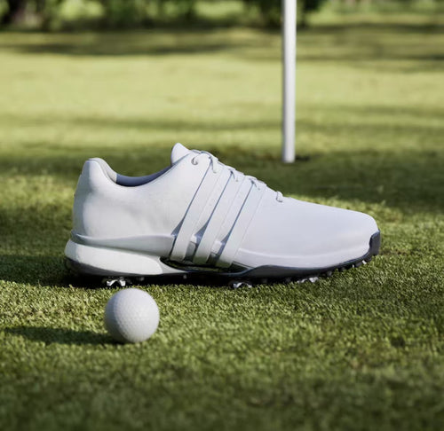 adidas Tour360 24 Boost white golf shoe beside a golf ball